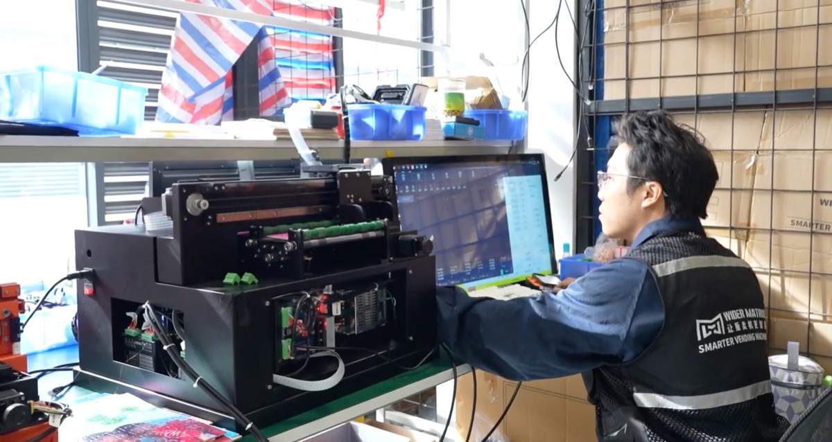 Wider Matrix engineer calibrating the WM880 printhead in the workshop